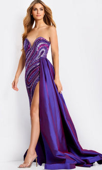 A woman wearing the Jovani Long Formal Dress 49226 in purple—strapless, sequined, with a thigh-high slit and flowing overskirt—paired with clear high-heeled shoes. - Image