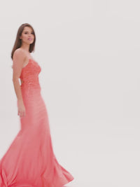 Video of model showing a long bright orange prom dress.